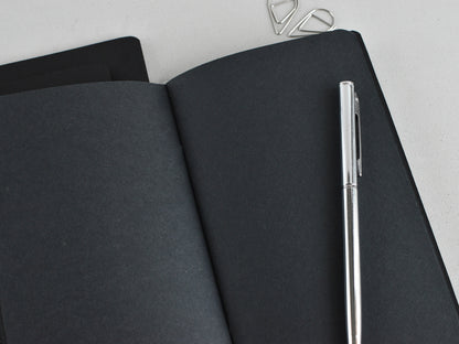 Black paper and white pen