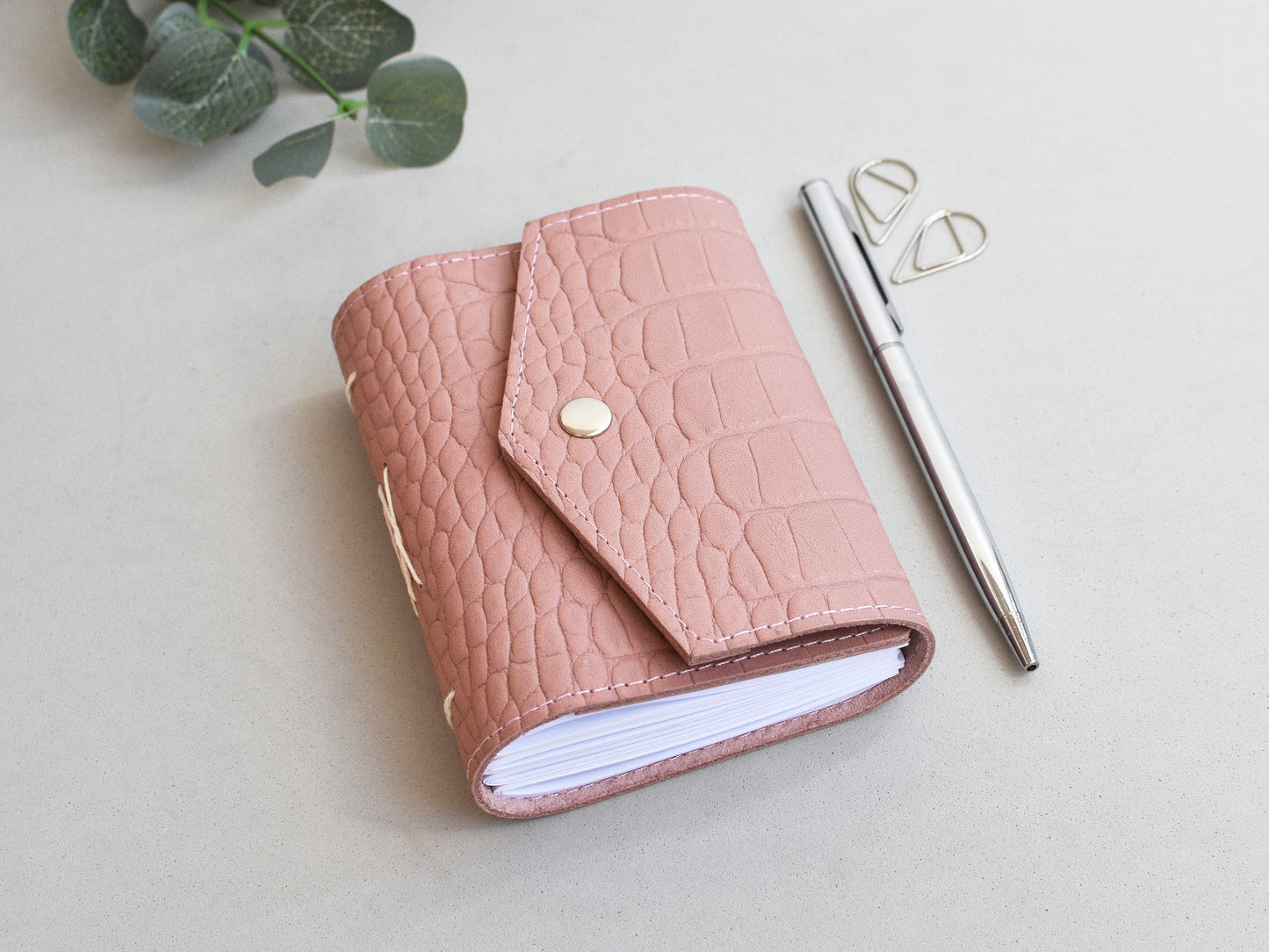 Small leather journal shown on the desk