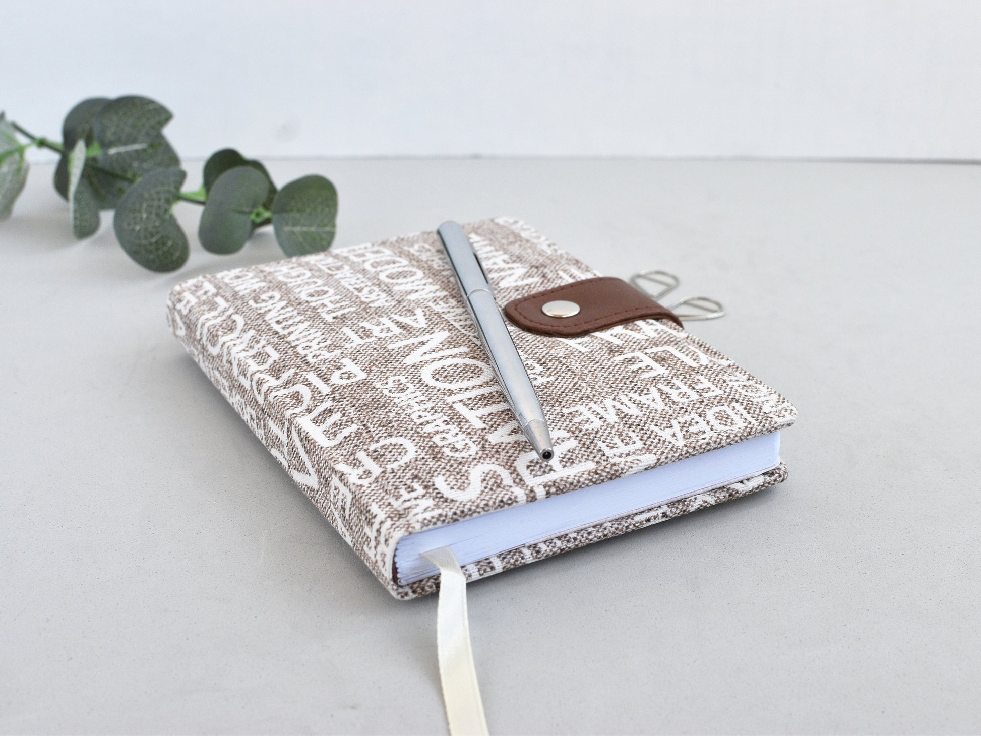 A6 planner covered with fabric, shown on the desk
