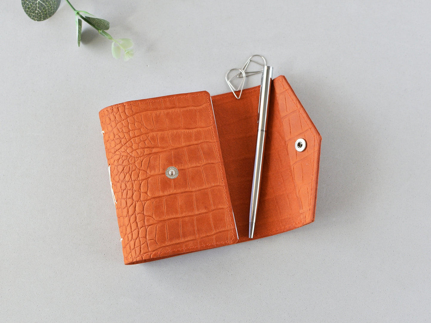 Opened leather journal, snap closure