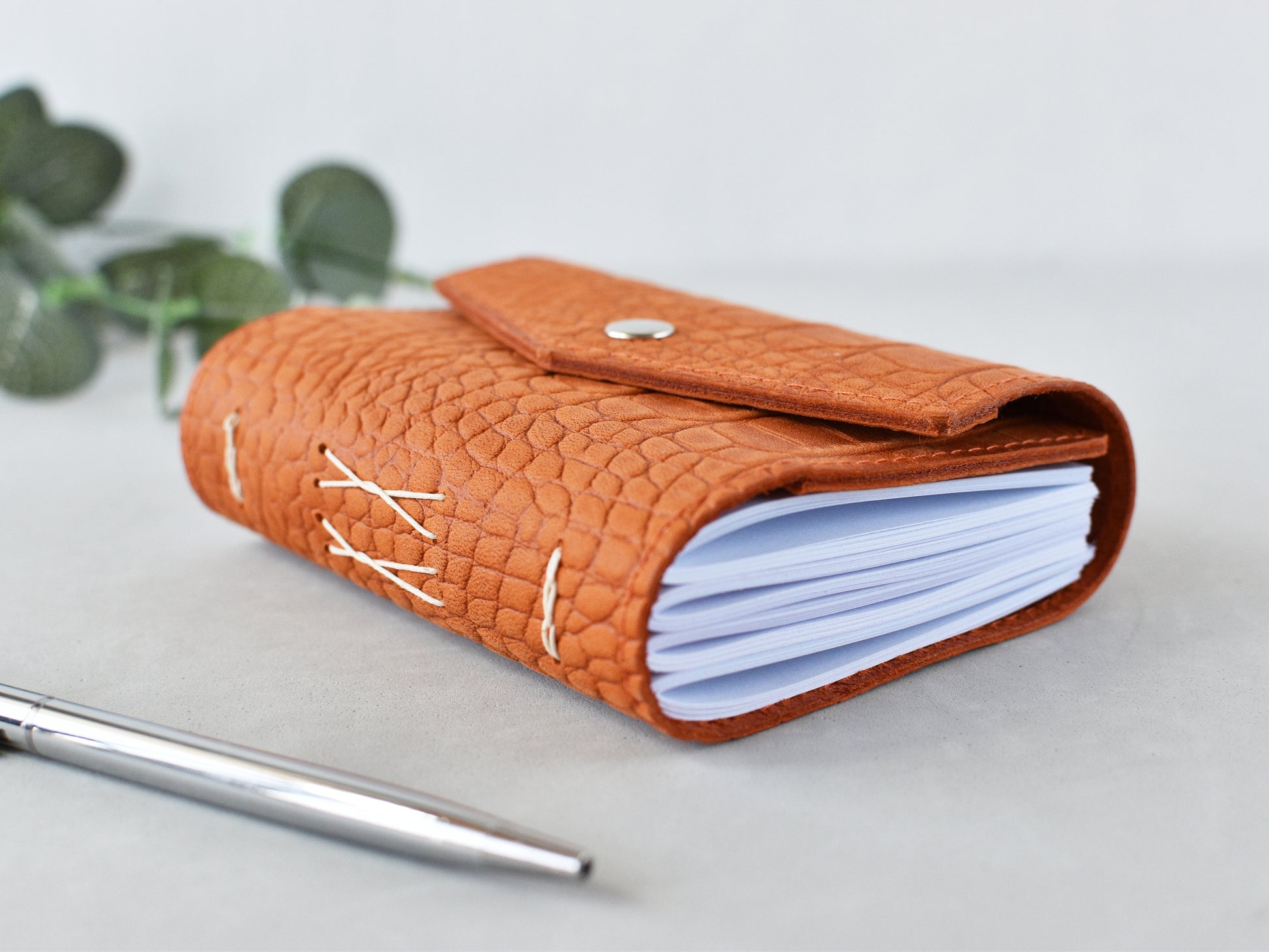 Leather softbook, orange color, shown on the desk