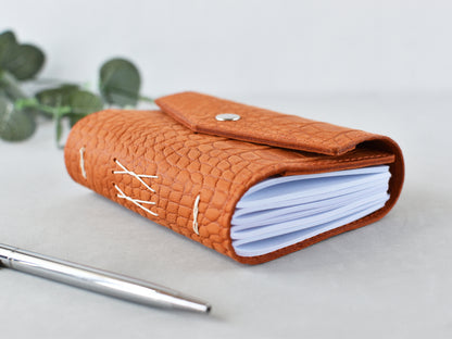 Leather softbook, orange color, shown on the desk