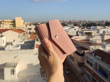 Croc leather pink notebook shown in hand